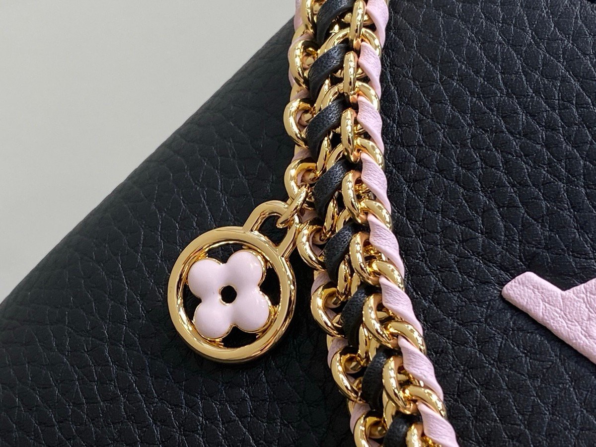 Black Braided Chain Top Handle Bag hardware detail view with smooth leather texture and braided chain detail
