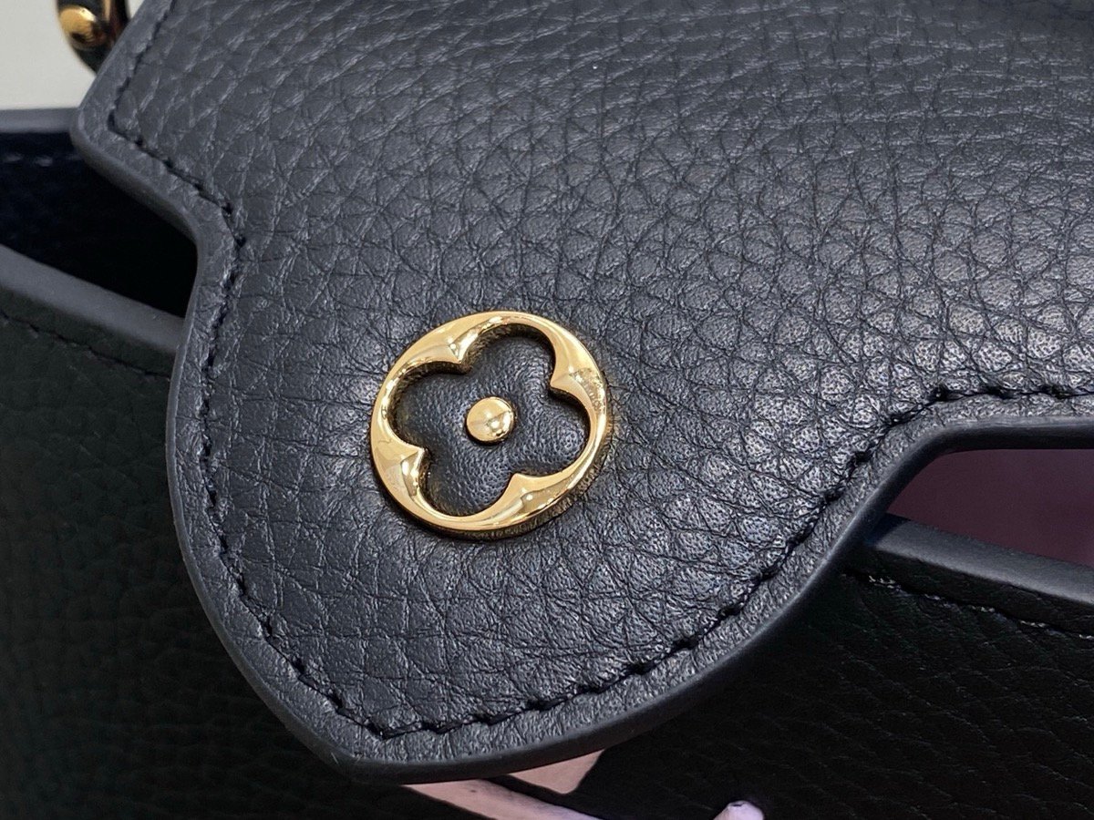 Black Braided Chain Top Handle Bag interior view with smooth leather texture and braided chain detail