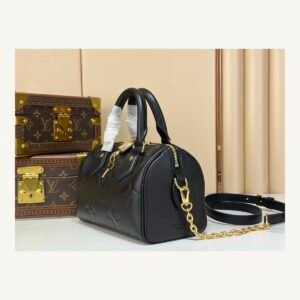 Black Embossed Compact Boston Bag angle view with embossed texture and silver tone hardware on neutral thumbnail background