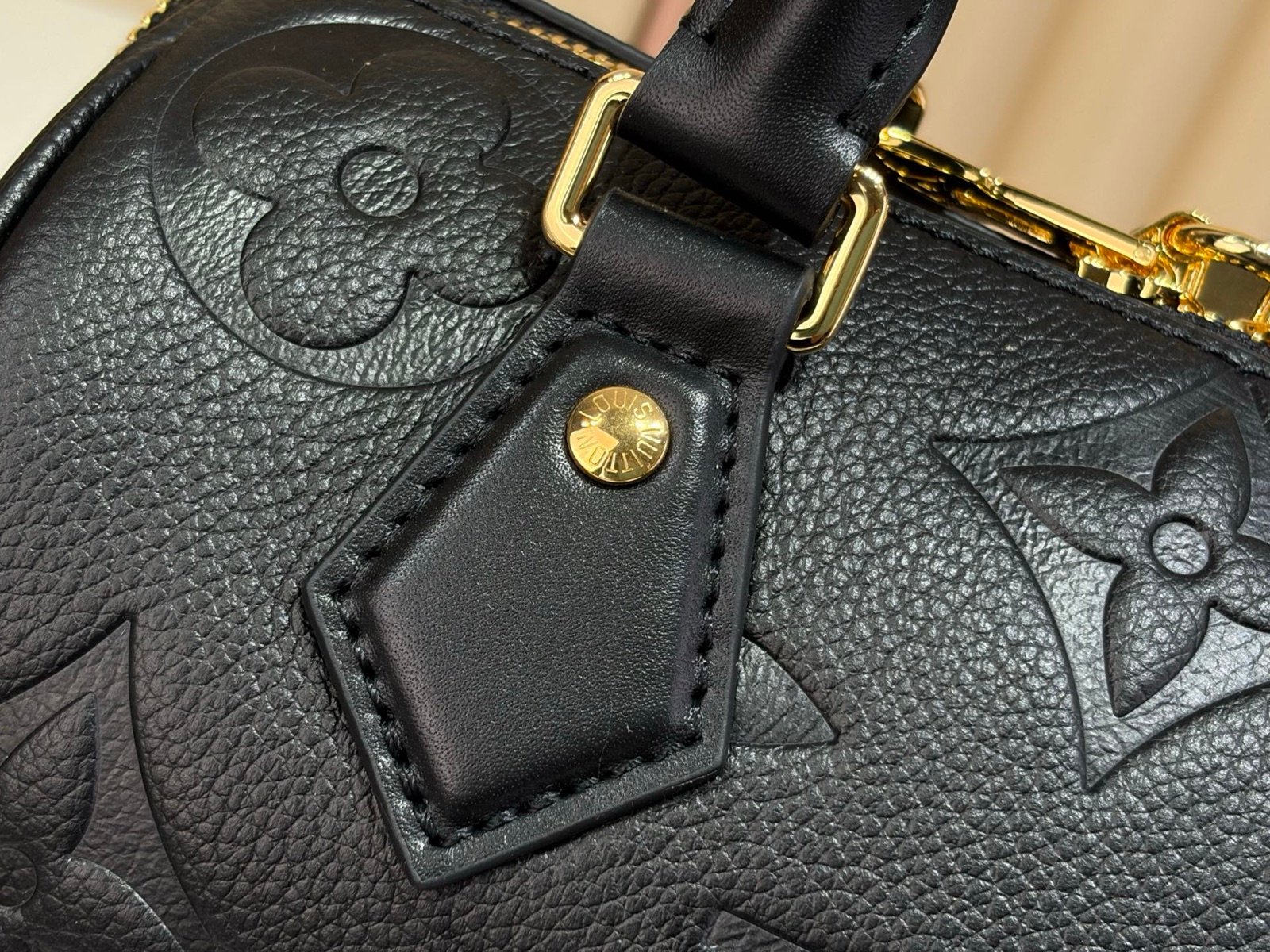 Black Embossed Compact Boston Bag hardware detail view with embossed texture and silver tone hardware