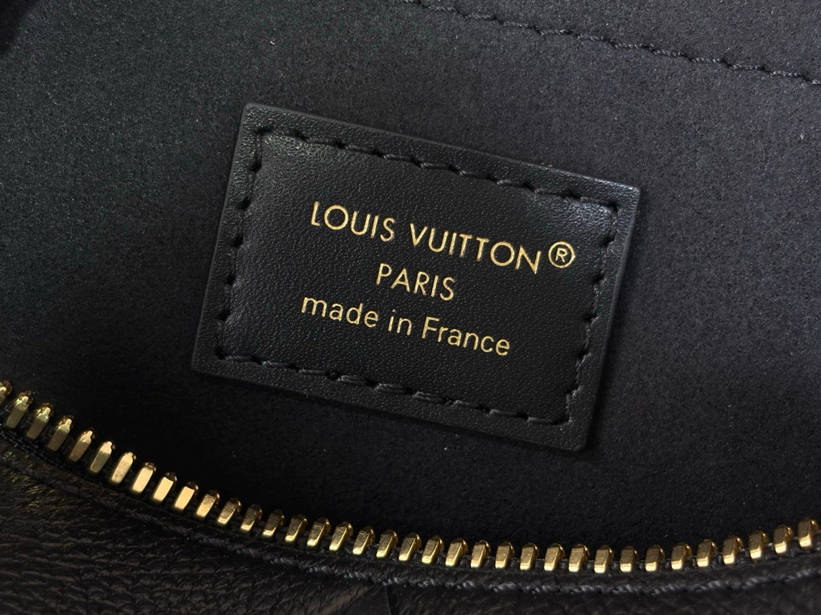Black Embossed Compact Boston Bag styling view with embossed texture and silver tone hardware