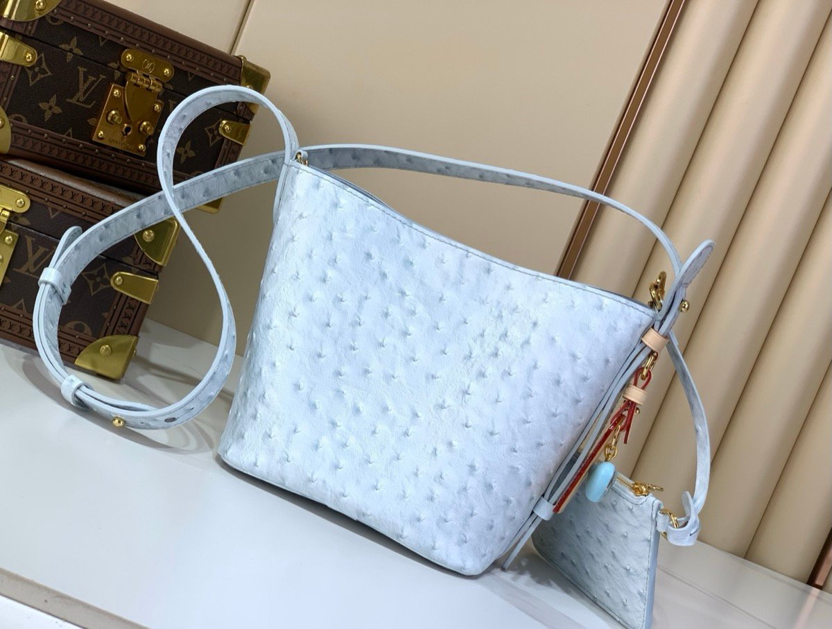 Blue Ostrich Texture Bucket Bag side view with ostrich texture and polished hardware
