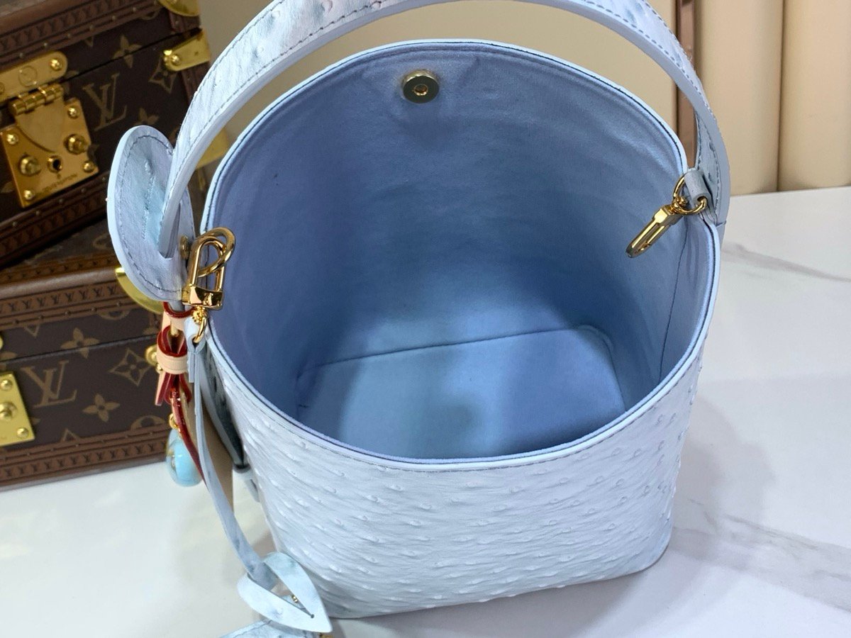Blue Ostrich Texture Bucket Bag styling view with ostrich texture and polished hardware