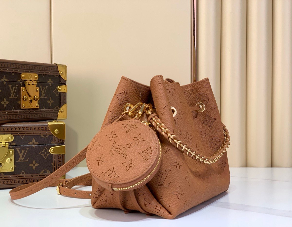 Brown Perforated Mini Bucket Bag angle view with perforated leather texture and braided handle
