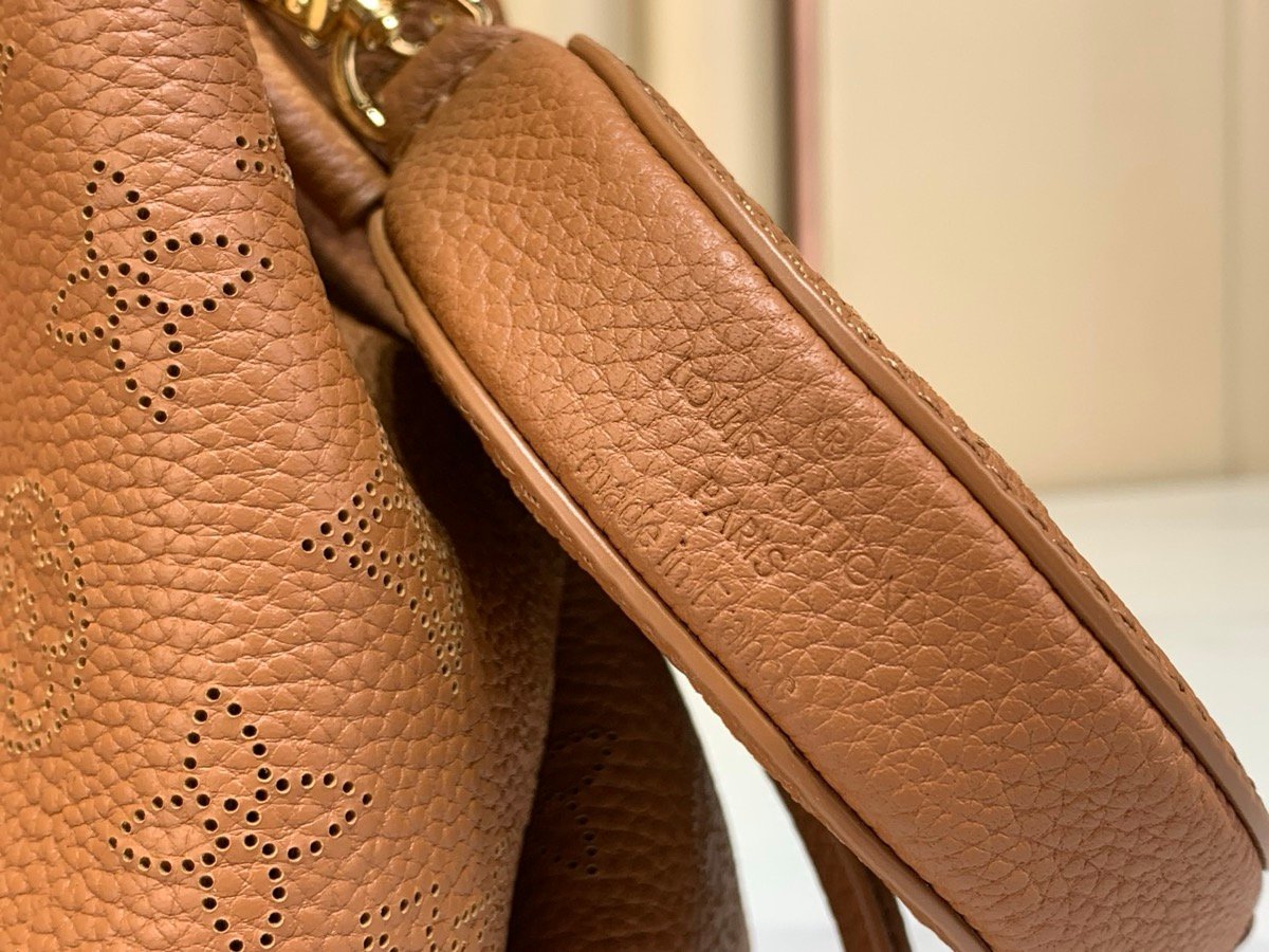 Brown Perforated Mini Bucket Bag detail view with perforated leather texture and braided handle