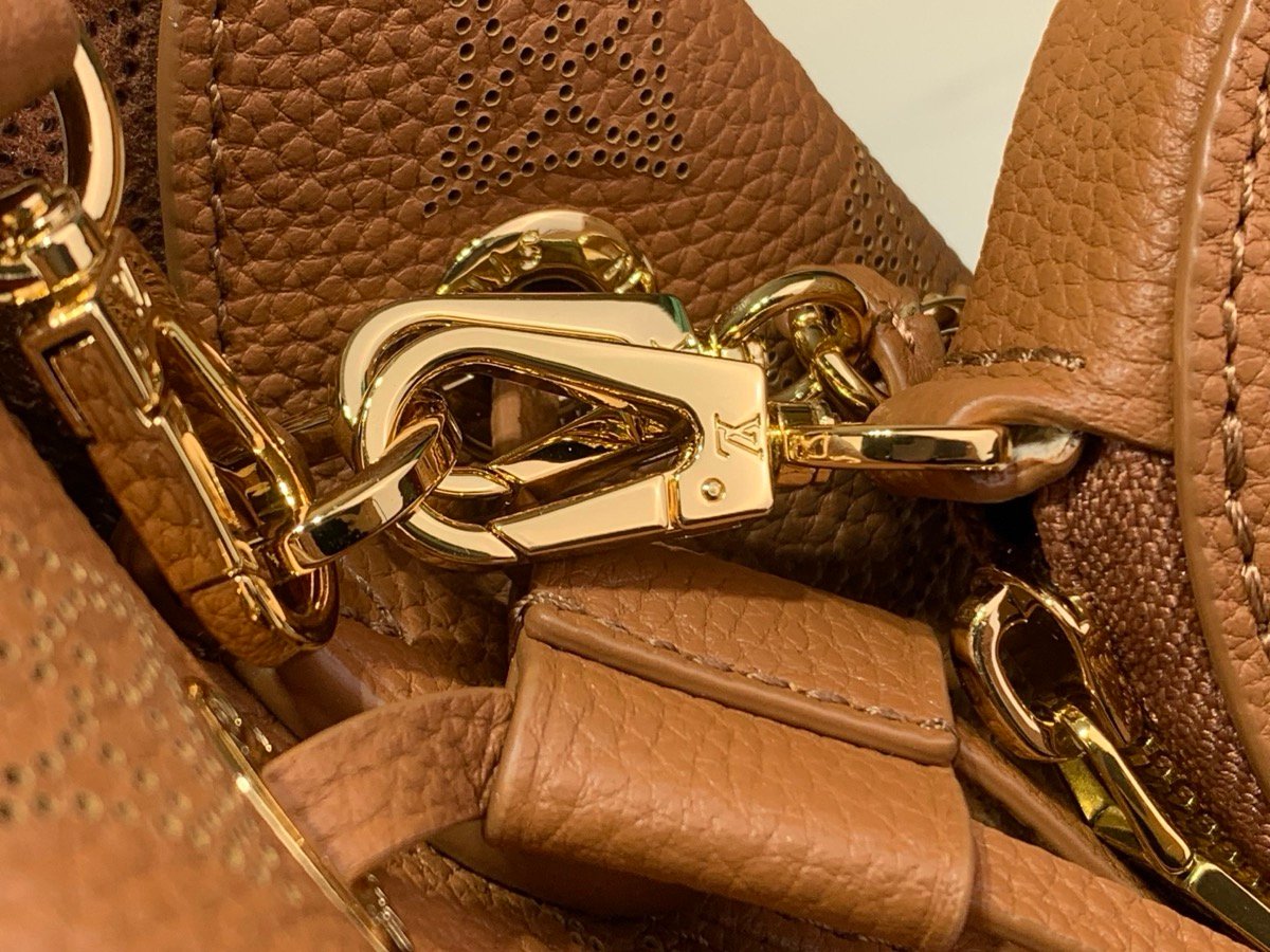 Brown Perforated Mini Bucket Bag hardware detail view with perforated leather texture and braided handle