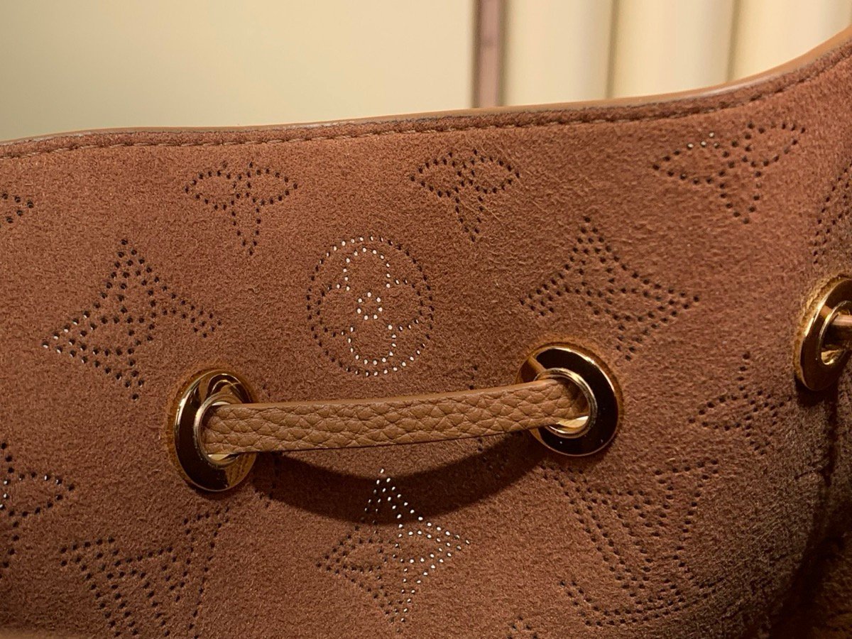 Brown Perforated Mini Bucket Bag interior view with perforated leather texture and braided handle