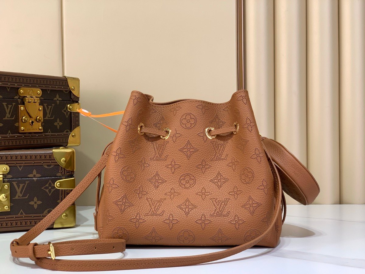 Brown Perforated Mini Bucket Bag side view with perforated leather texture and braided handle