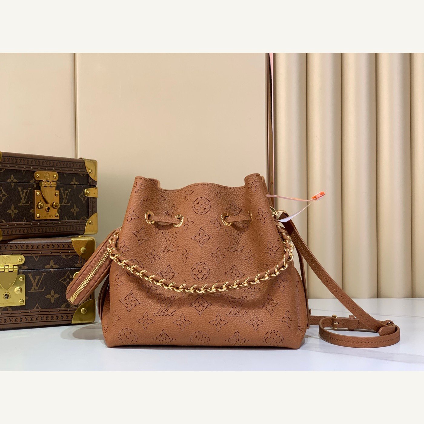 Brown Perforated Mini Bucket Bag full front view on neutral thumbnail background