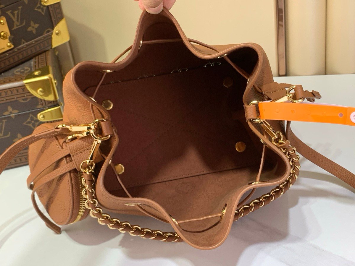 Brown Perforated Mini Bucket Bag styling view with perforated leather texture and braided handle