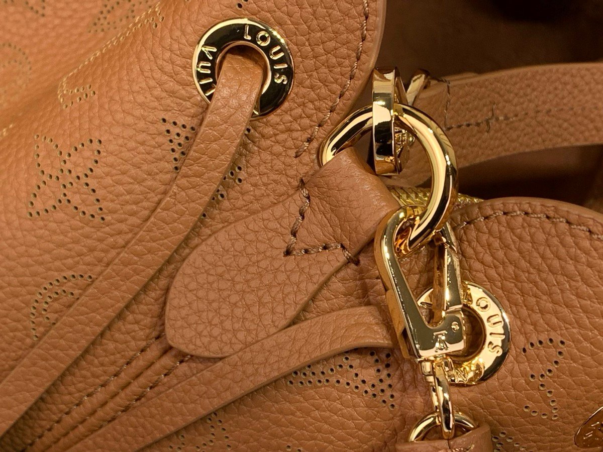 Brown Perforated Soft Tote Bag strap detail view with perforated leather texture and chain detail