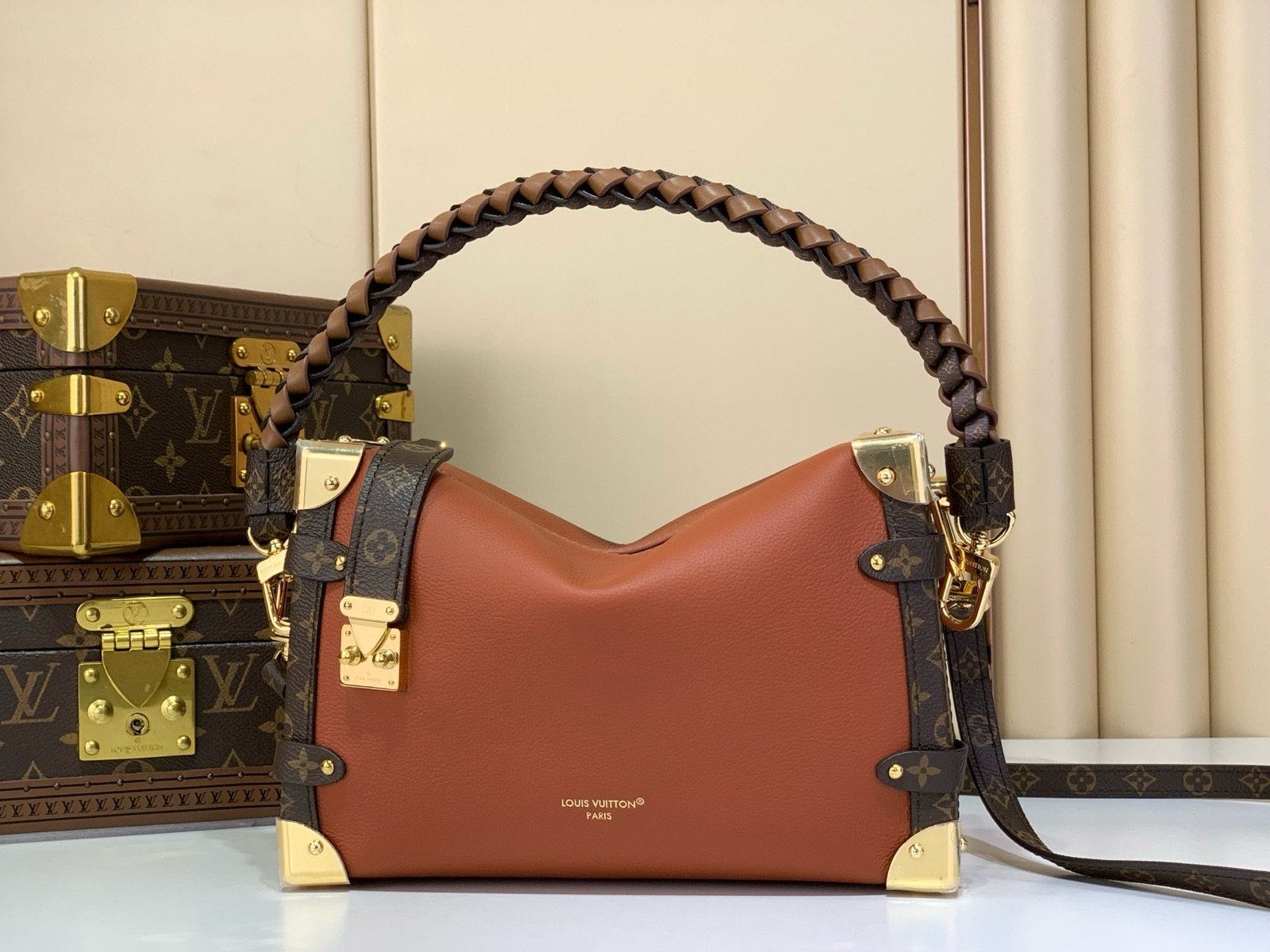 Brown Woven Medium Trunk Bag angle view with woven strap and gold tone hardware
