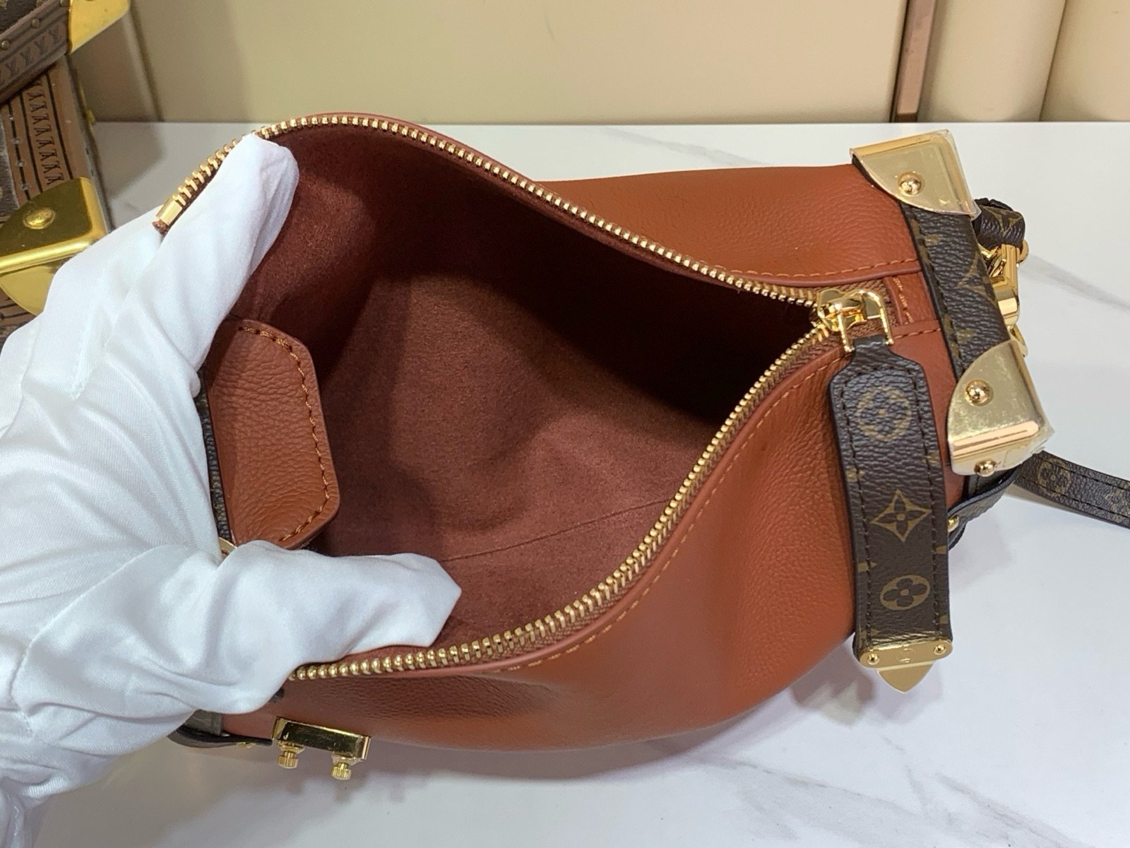 Brown Woven Medium Trunk Bag interior view with woven strap and gold tone hardware
