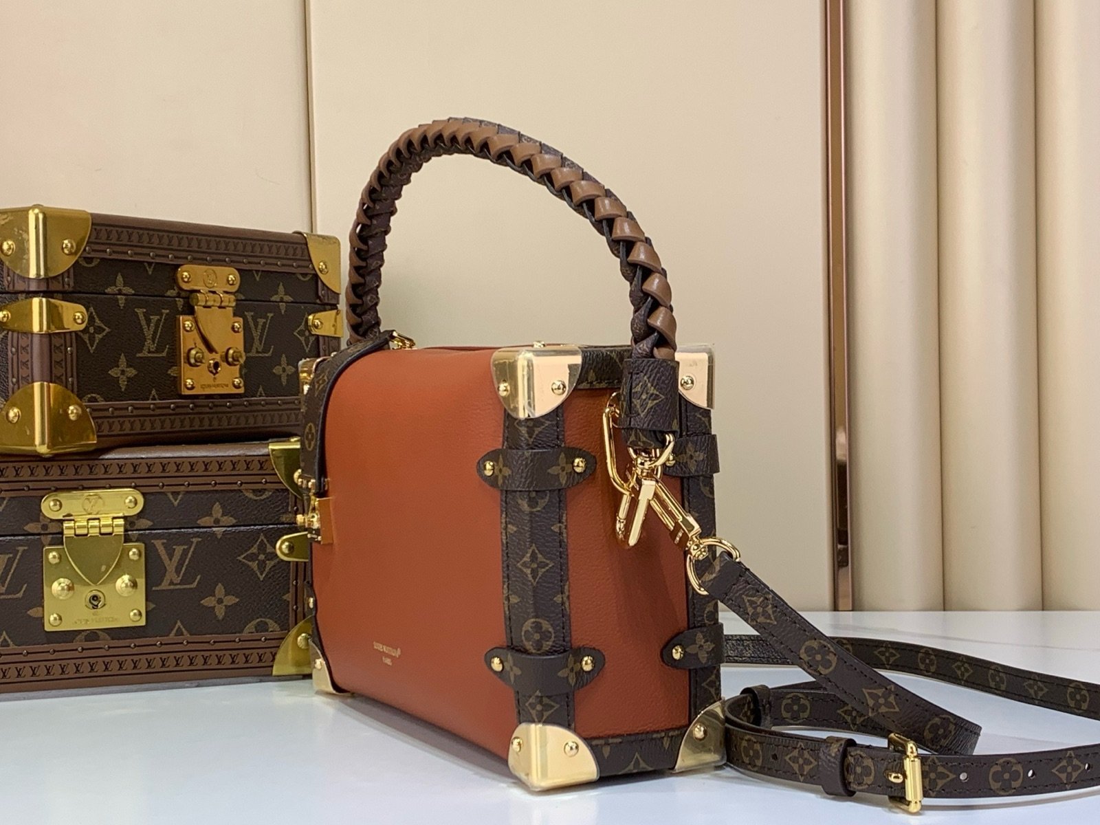 Brown Woven Medium Trunk Bag side view with woven strap and gold tone hardware