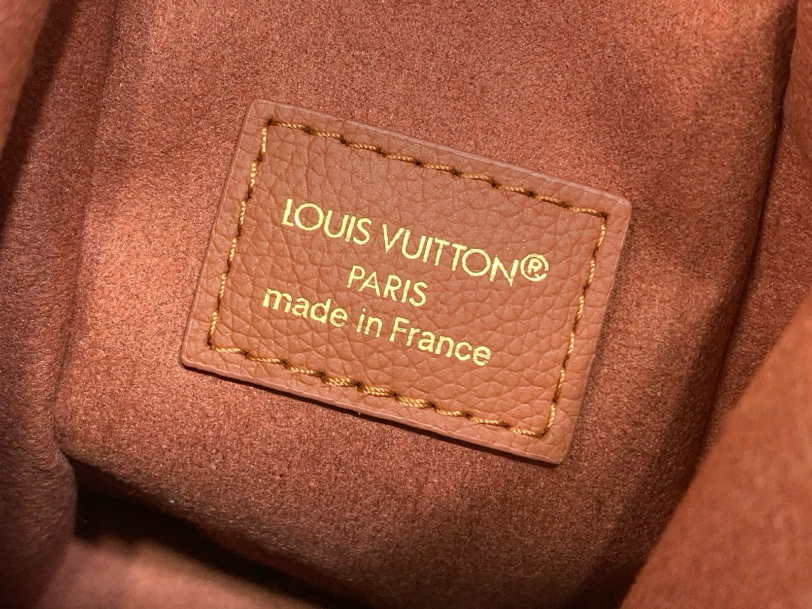 Brown Woven Medium Trunk Bag styling view with woven strap and gold tone hardware