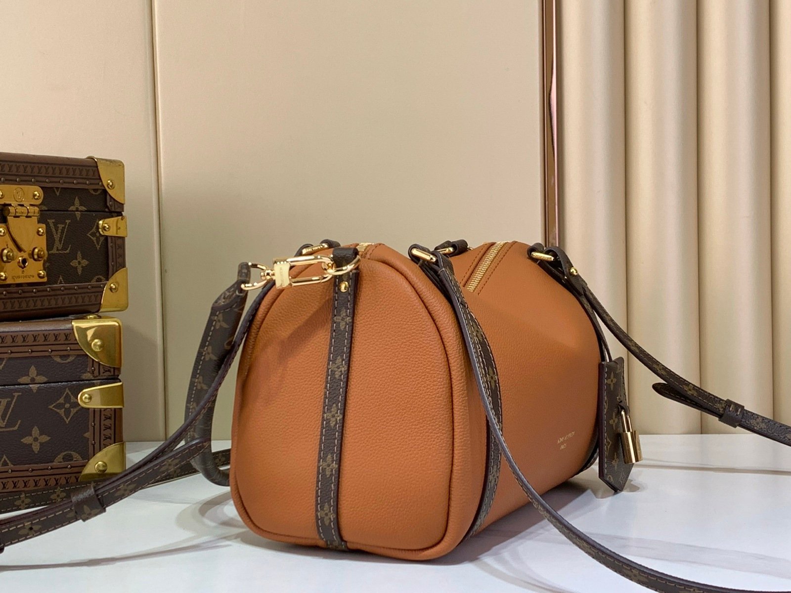 Cognac Brown Small Crossbody Bag angle view with grained leather texture with patterned strap details