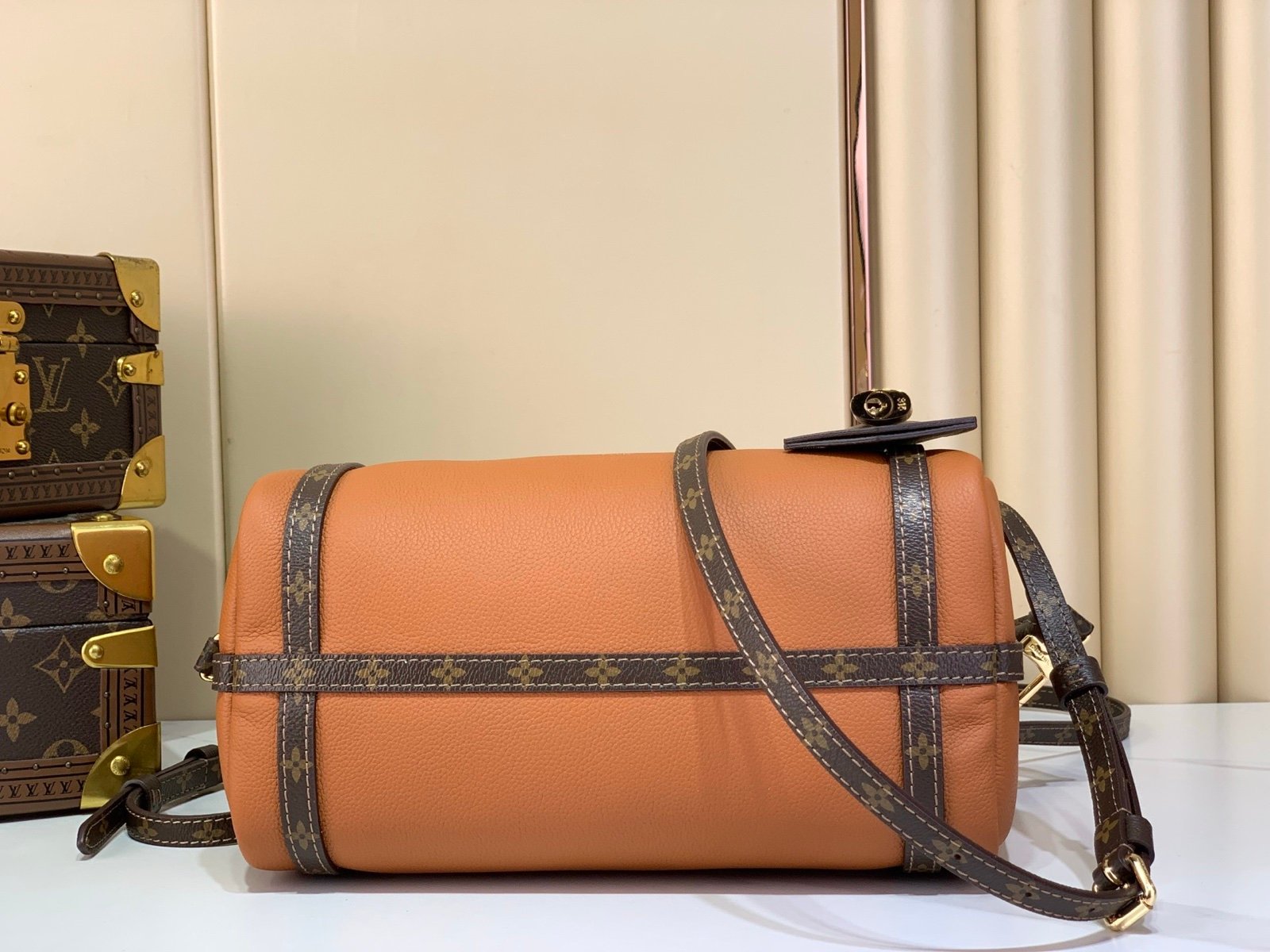 Cognac Brown Small Crossbody Bag back view with grained leather texture with patterned strap details