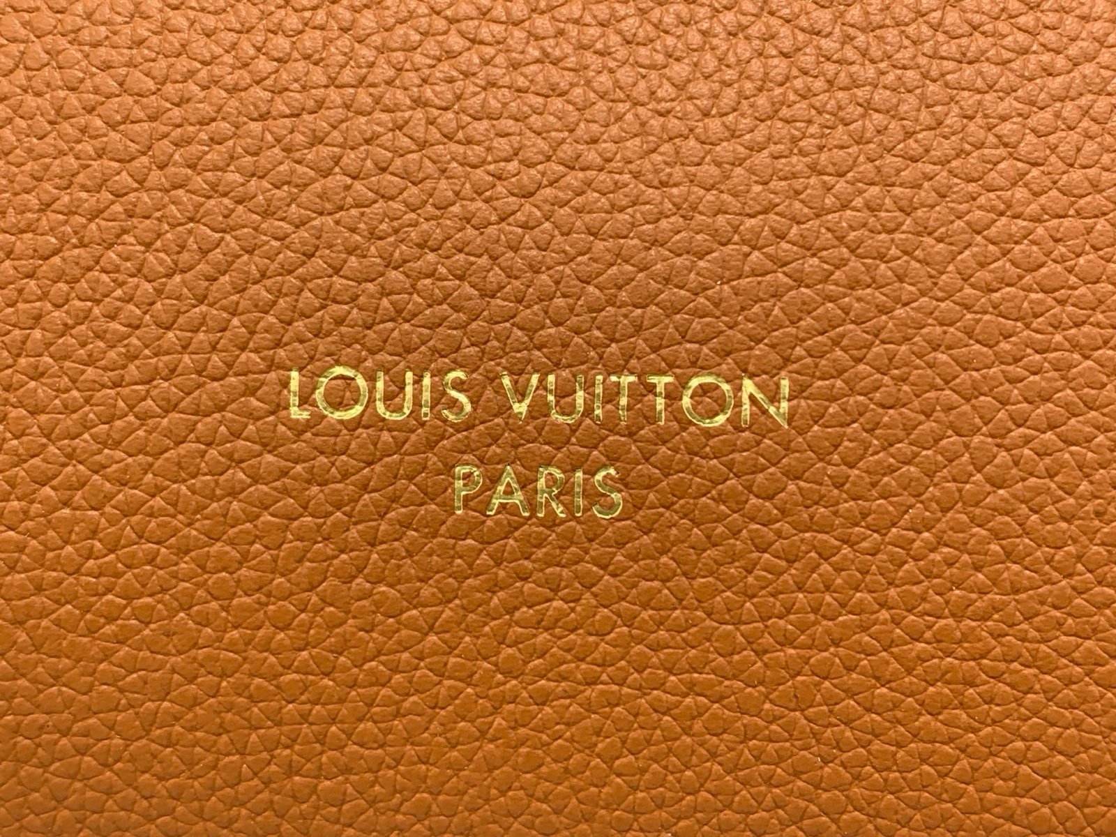 Cognac Brown Small Crossbody Bag detail view with grained leather texture with patterned strap details