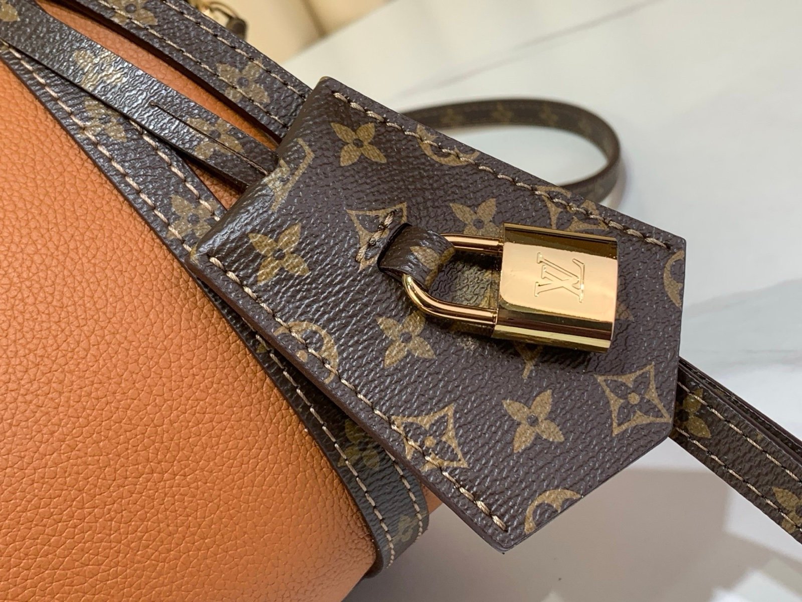 Cognac Brown Small Crossbody Bag hardware detail view with grained leather texture with patterned strap details