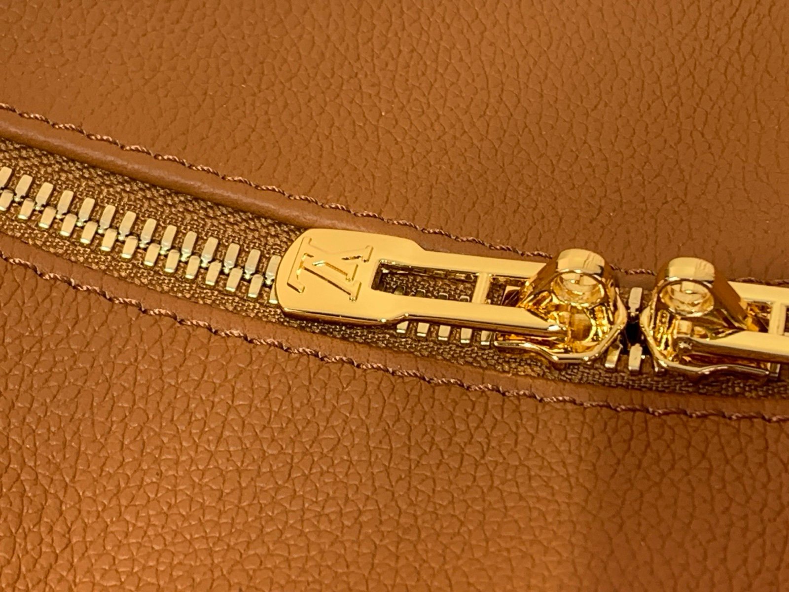 Cognac Brown Small Crossbody Bag strap detail view with grained leather texture with patterned strap details