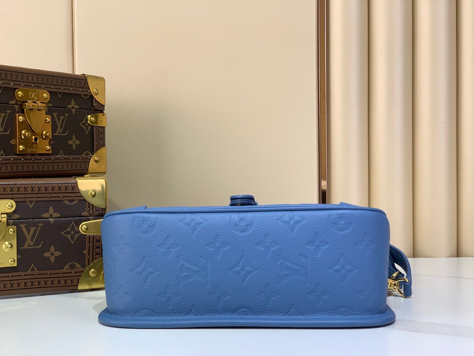 Mist Blue Embossed Baguette Bag back view with embossed grained texture with a wide woven strap