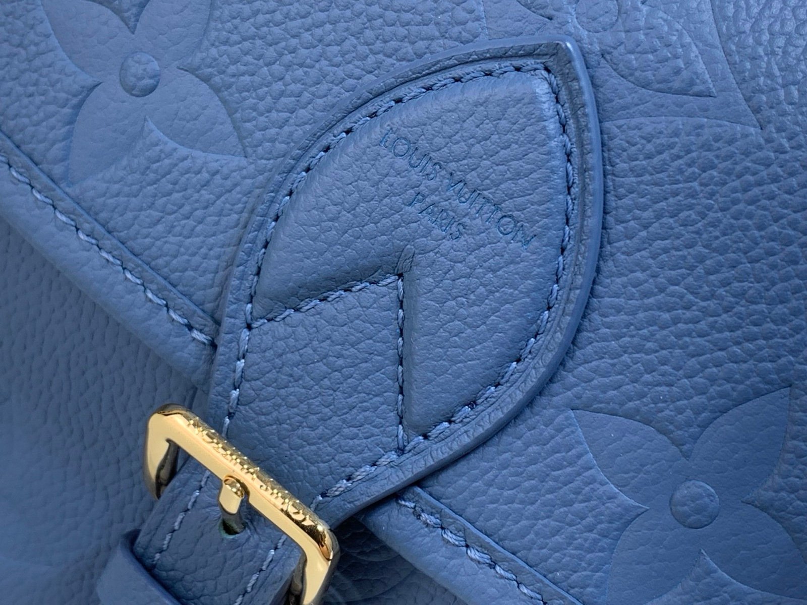 Mist Blue Embossed Baguette Bag detail view with embossed grained texture with a wide woven strap
