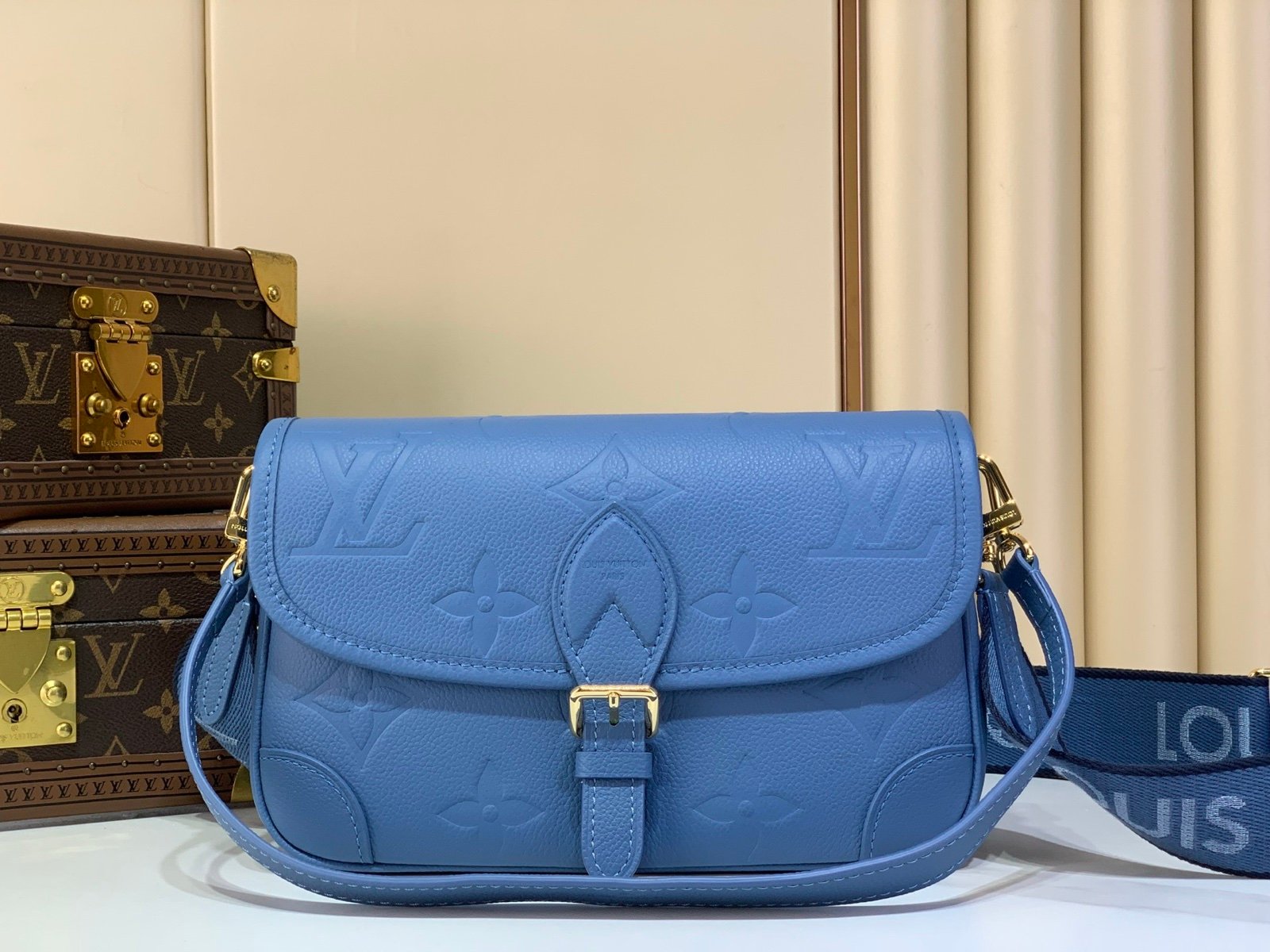 Mist Blue Embossed Baguette Bag front view with embossed grained texture with a wide woven strap