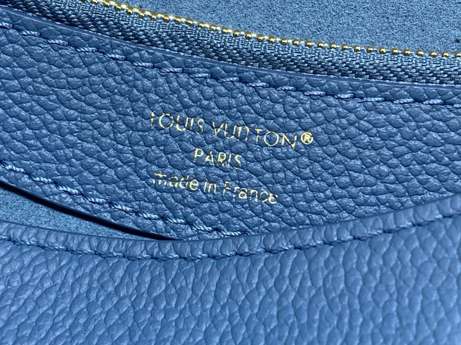 Mist Blue Embossed Baguette Bag interior view with embossed grained texture with a wide woven strap