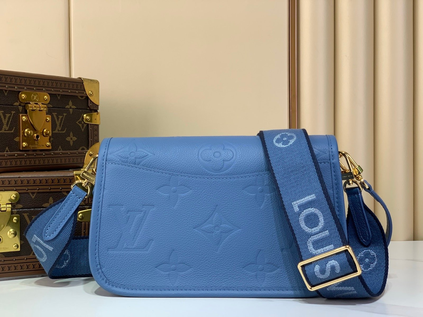 Mist Blue Embossed Baguette Bag side view with embossed grained texture with a wide woven strap