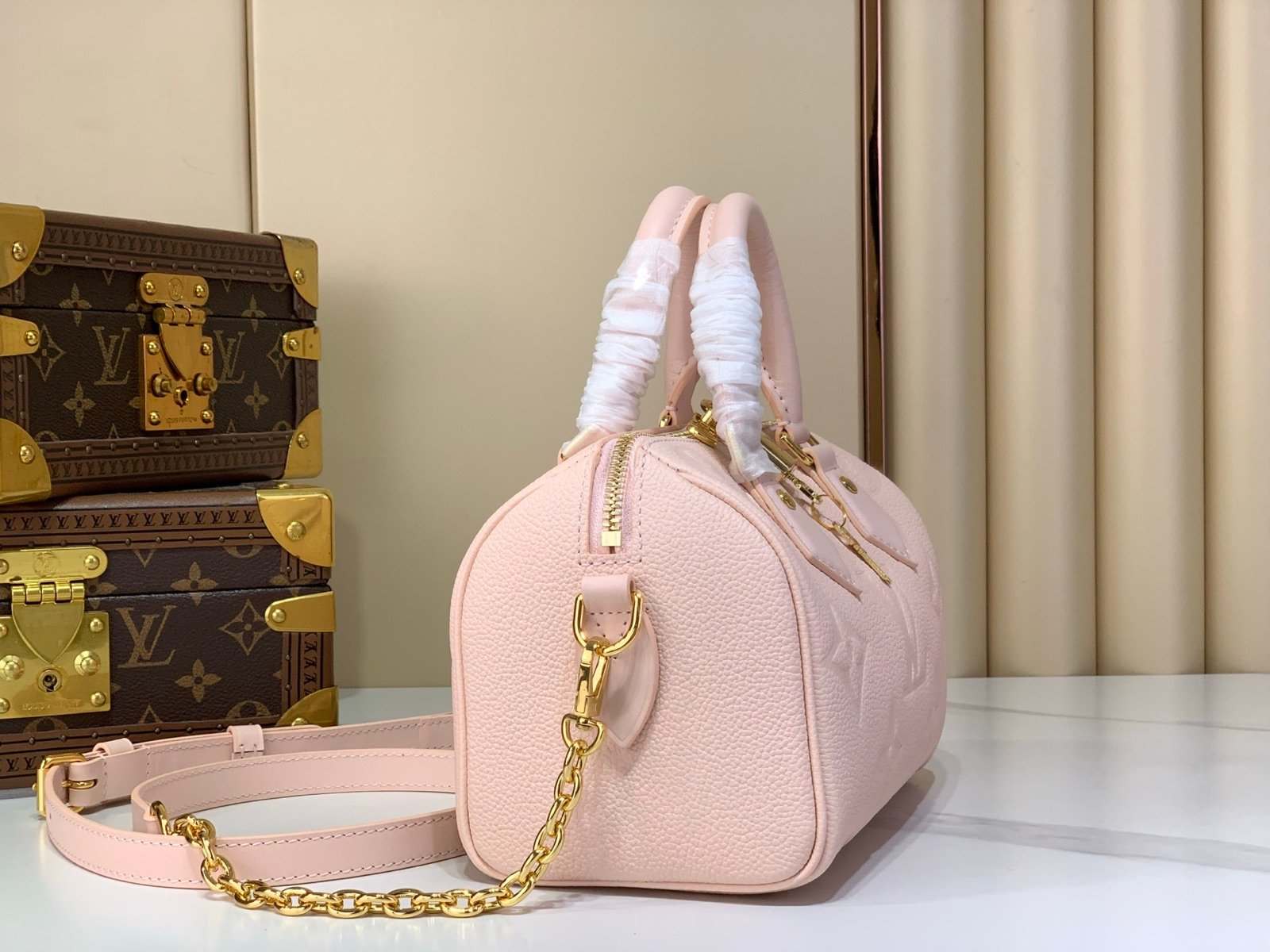 Pink Embossed Compact Boston Bag angle view with embossed texture and silver tone hardware