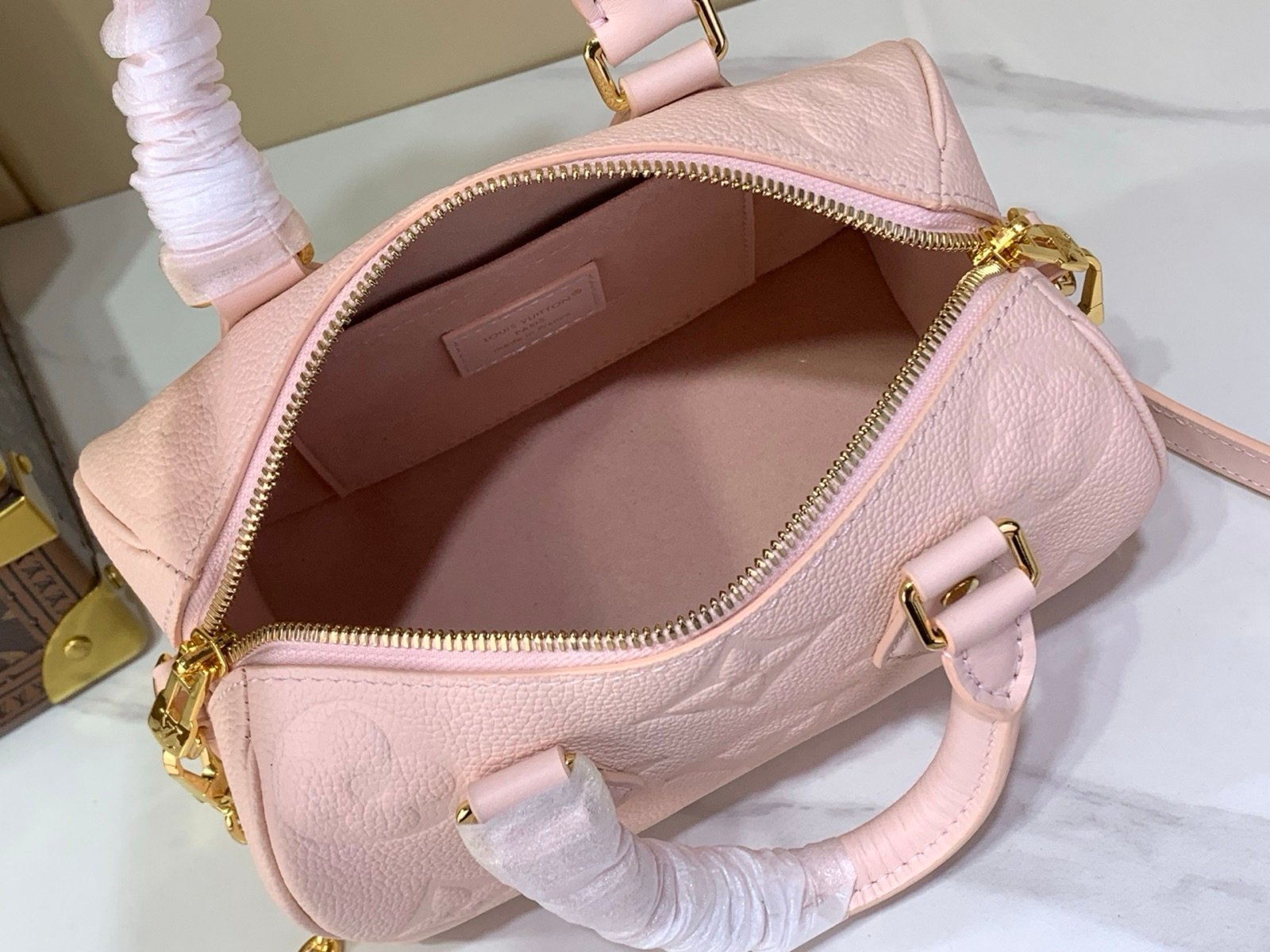 Pink Embossed Compact Boston Bag strap detail view with embossed texture and silver tone hardware