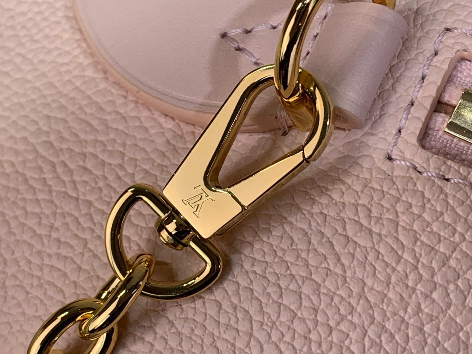 Pink Embossed Compact Boston Bag styling view with embossed texture and silver tone hardware