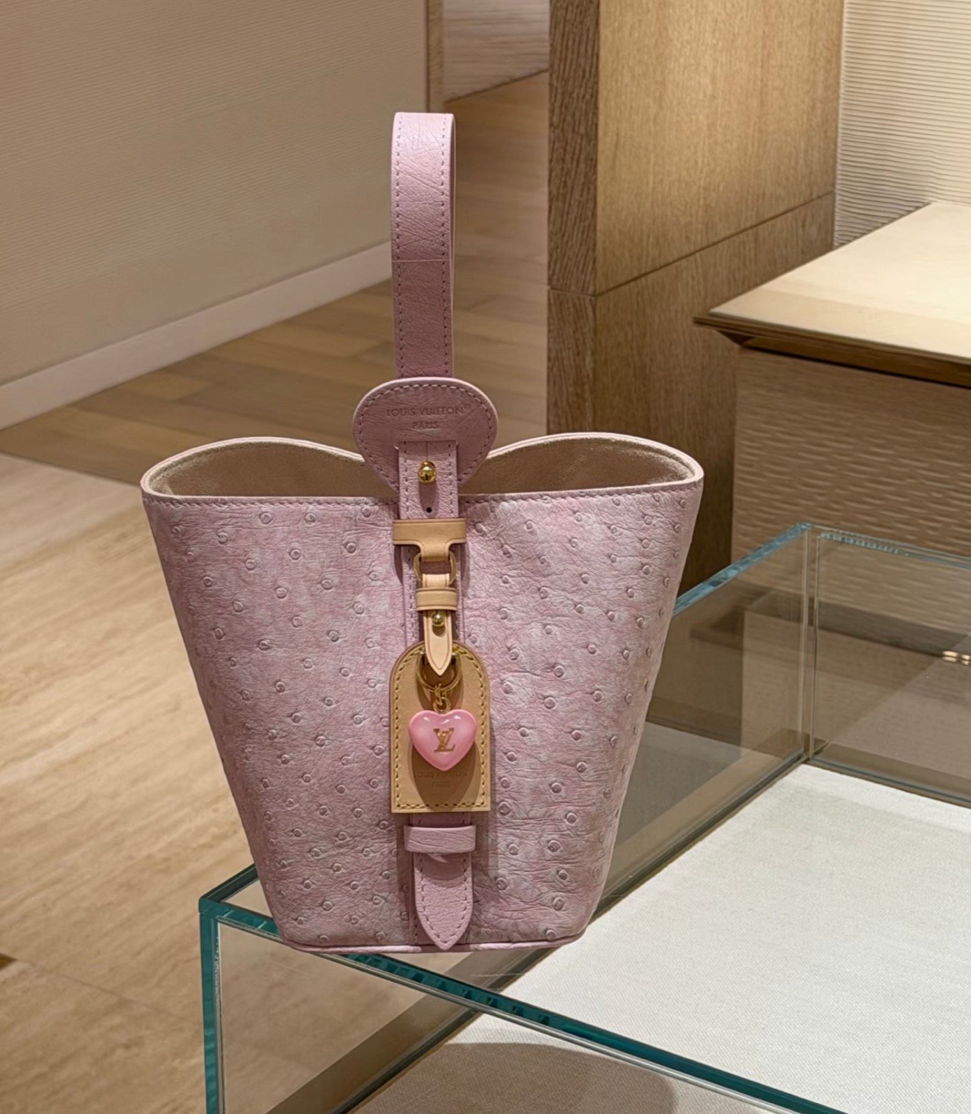 Pink Ostrich Texture Bucket Bag detail view with ostrich texture and smooth trim