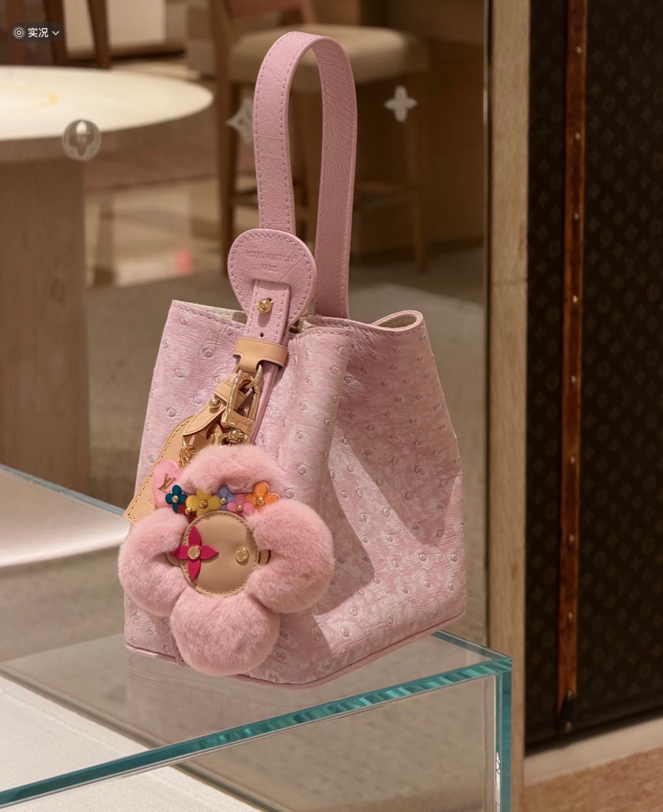 Pink Ostrich Texture Bucket Bag styling view with ostrich texture and smooth trim