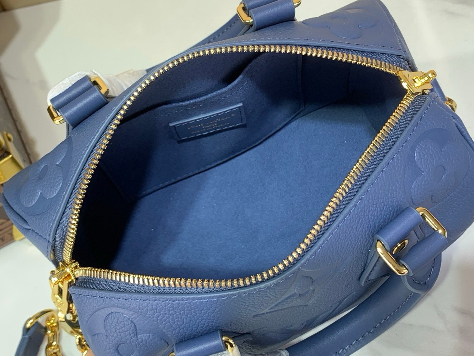 Royal Blue Embossed Compact Boston Bag interior view with embossed texture and silver tone hardware