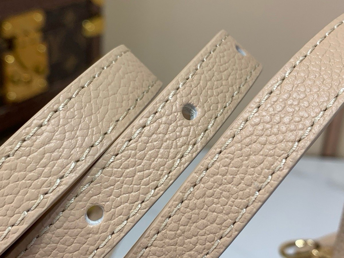 Taupe Embroidered Top Handle Bag styling view with embroidered texture and smooth trim
