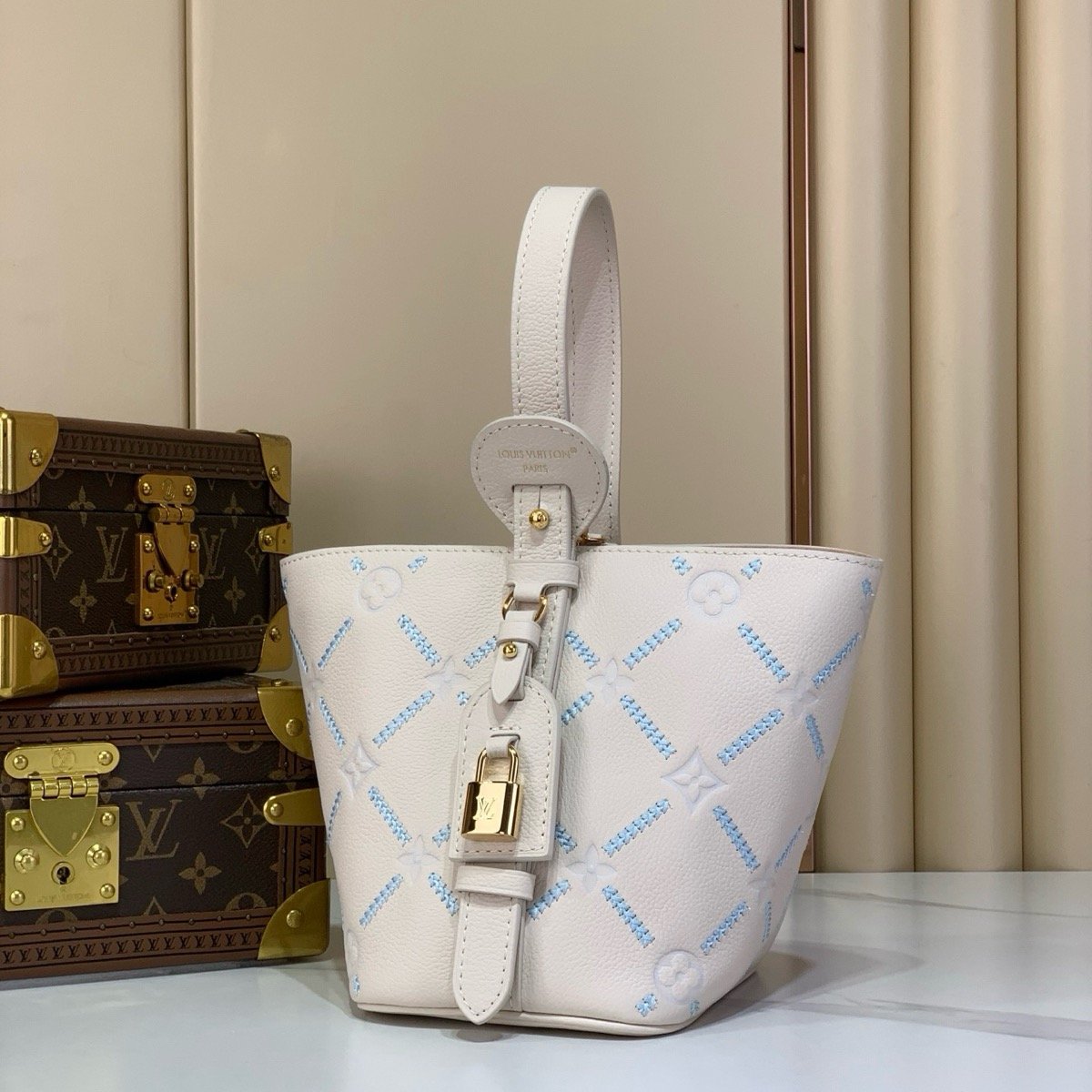 White Embroidered Bucket Bag angle view with embroidered texture and light trim