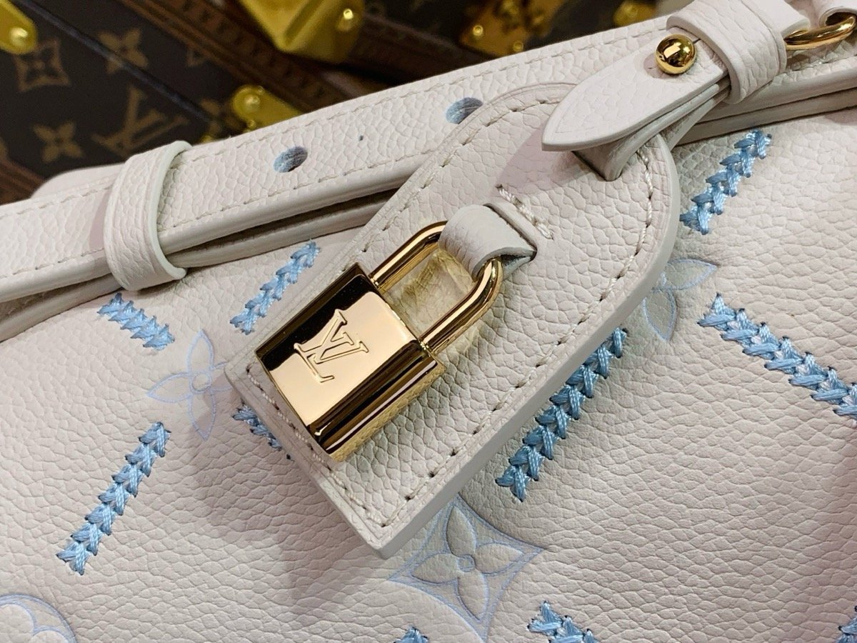 White Embroidered Bucket Bag hardware detail view with embroidered texture and light trim