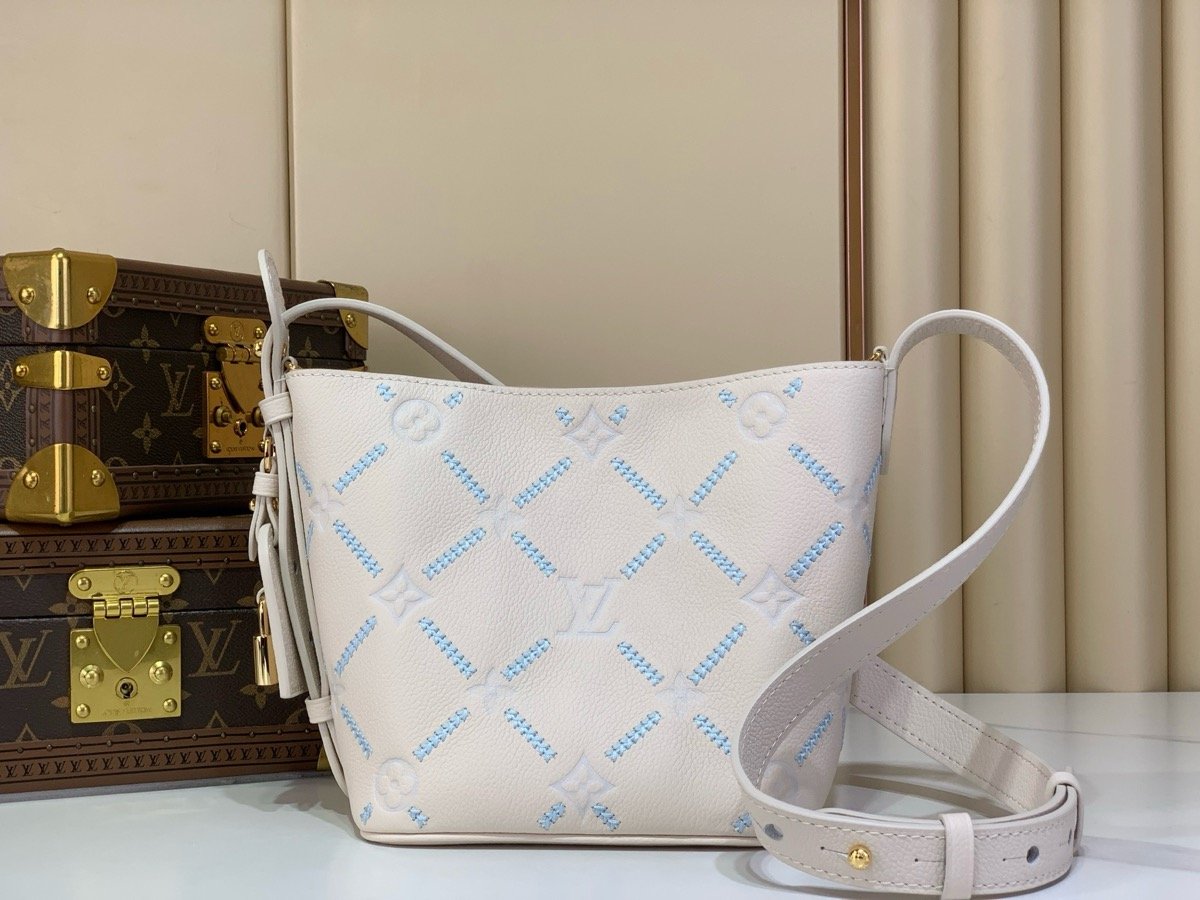 White Embroidered Bucket Bag side view with embroidered texture and light trim
