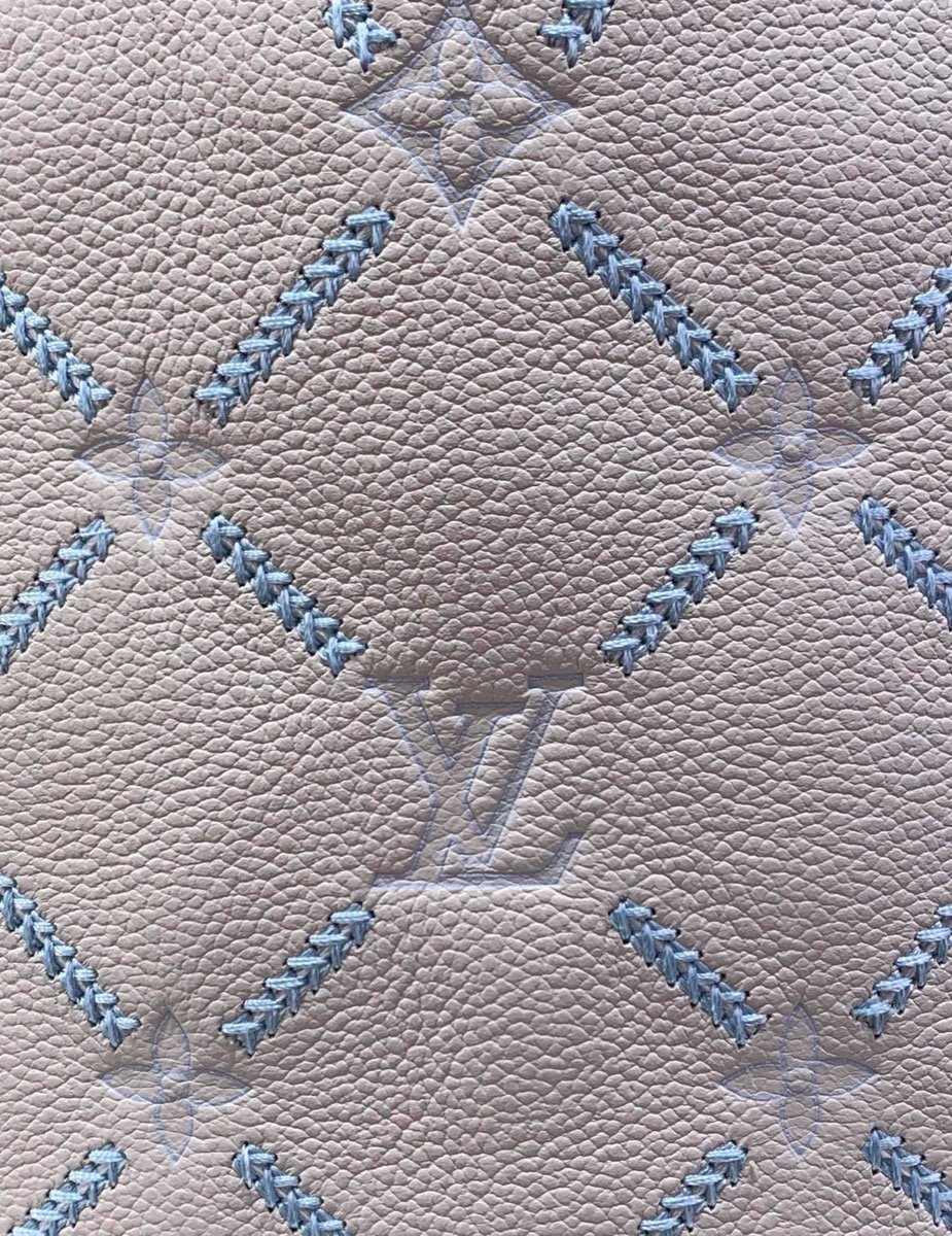 White Embroidered Bucket Bag strap detail view with embroidered texture and light trim