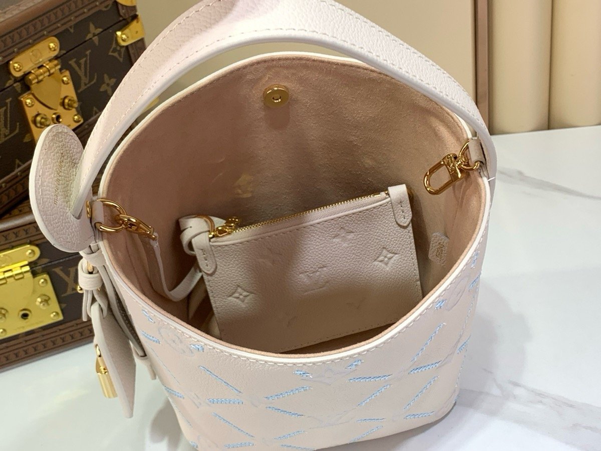 White Embroidered Bucket Bag styling view with embroidered texture and light trim