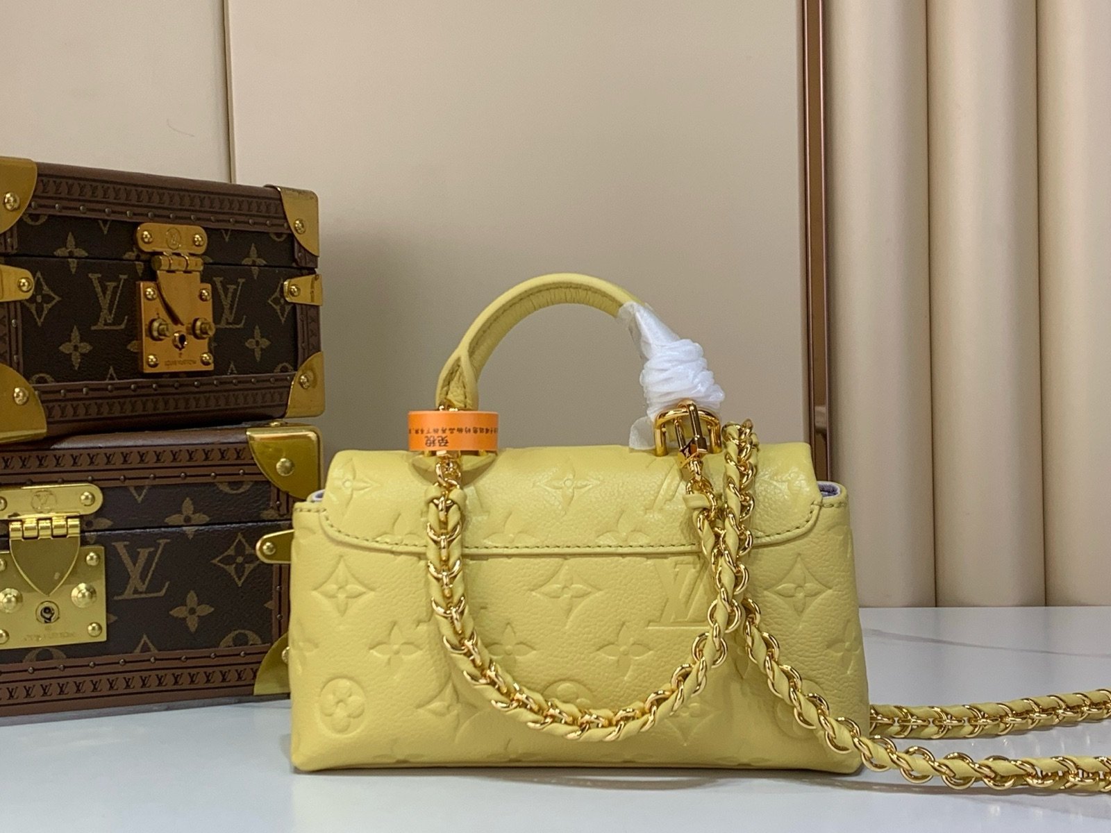 Yellow And Purple Nano Top Handle Bag side view with smooth color finish and compact handle